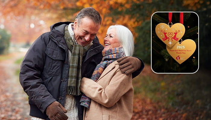 Couple walking outside in the fall, laughing. Ornament offer in top right corner