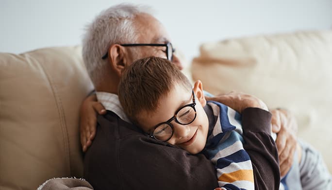Grandfather and grandson hugging