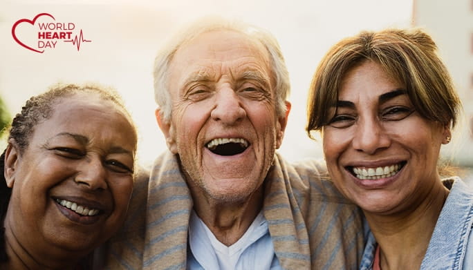Three people smiling at the camera for World Heart Day