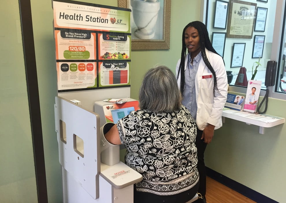 Jesse Hoe of the Student National Pharmaceutical Association (SNPhA) teaches a community member how to take her blood pressure at a wellness clinic Jesse Hoe of the Student National Pharmaceutical Association (SNPhA) teaches a community member how to take her blood pressure
