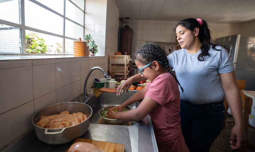 Mother teaching daughter to cook