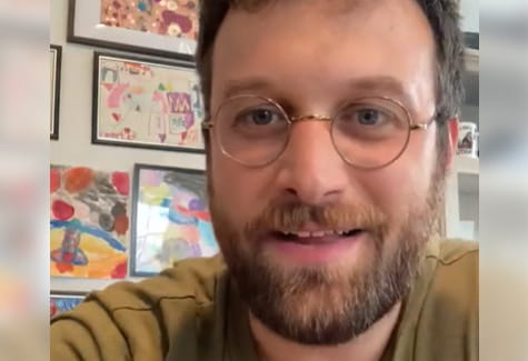 Close-up of a smiling Mike Parker wearing glasses