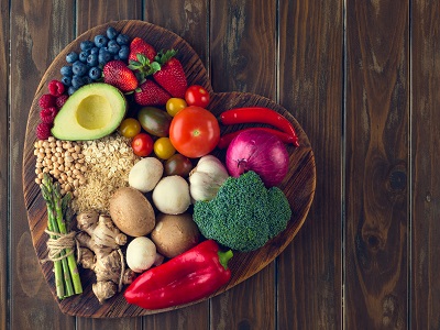 Colorful fruits and vegetables in a heart shaped bowl