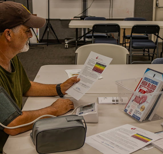 San Benito Library patron Edward Smith takes a blood pressure reading.  copyright San Benito Library