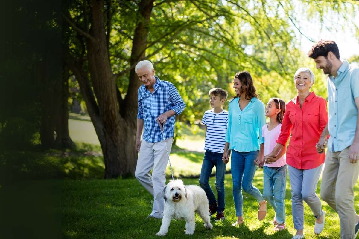multi-generational family walking in green park