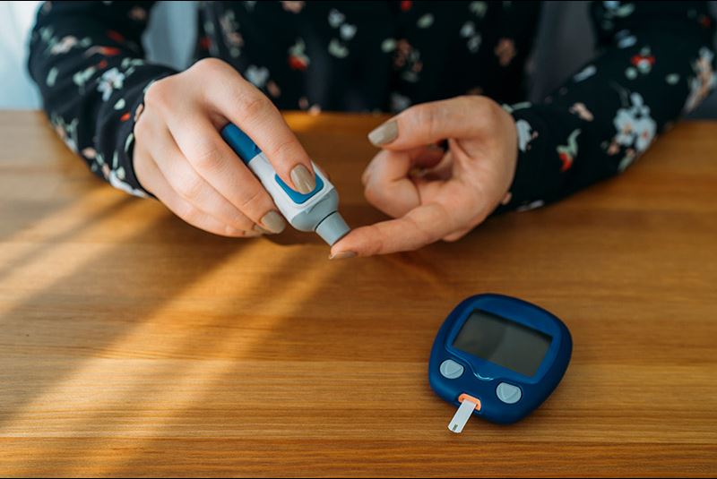 Woman testing her blood sugar