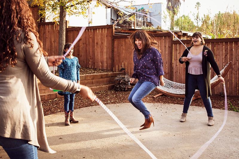 Woman jumping rope with girls
