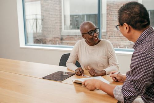 A client meeting with an advisor and looking at documents together