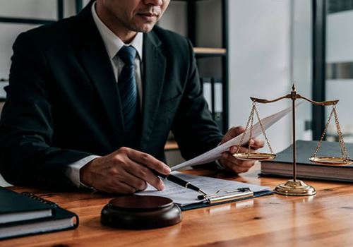 advisor wearing a suit sitting at a desk and examining documents
