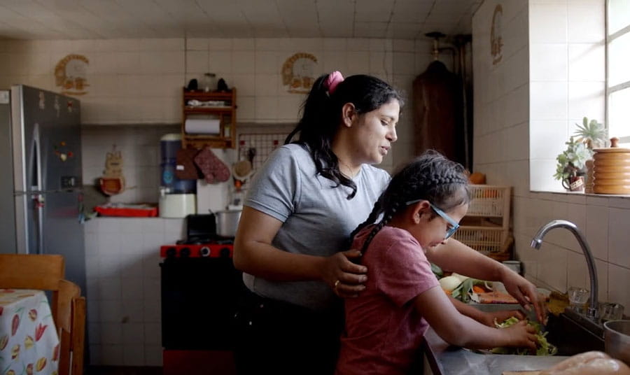 Mom helping daughter wash hands