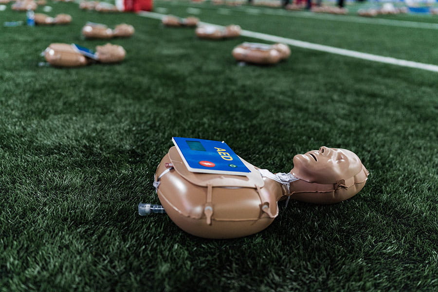 inflatable manikins on a sports field at a CPR Event
