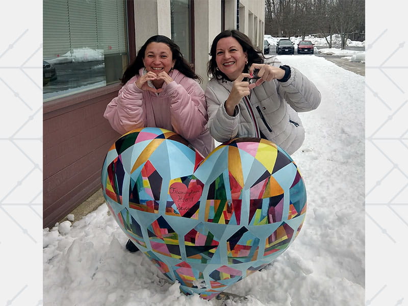 Sisters Ximena (left) and Monica Martinez smile outside the Framingham Heart Study after an all‑night drive.