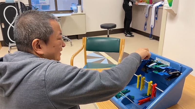 Stroke survivor Yutao Huang at therapy