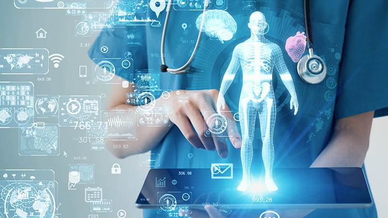 A graphic overlay of data and infographics over a close up of the hands of a healthcare worker holding a tablet
