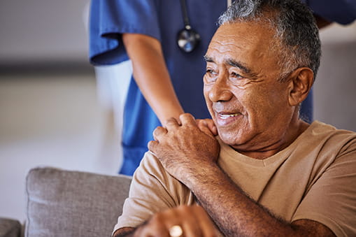 Close up of patient holding the hand of a health care worker