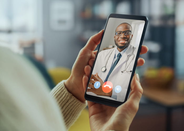 Physician on smart phone for telehealth visit.