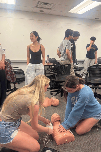 Students participating in a Hands Only CPR demo