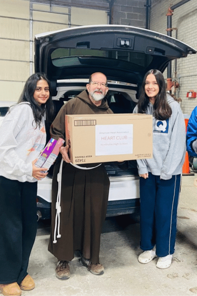 Student delivering food drive boxes