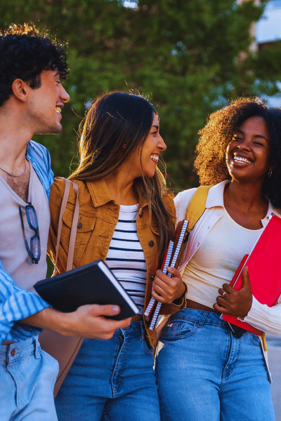 three students talking outside