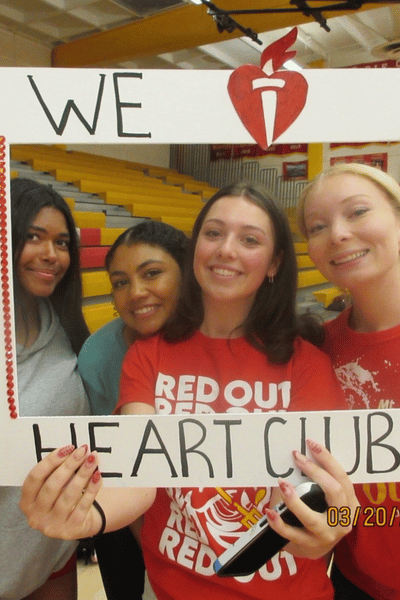 Four students in an "We love Heart Club" frame