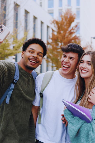 three students posing for a selfie