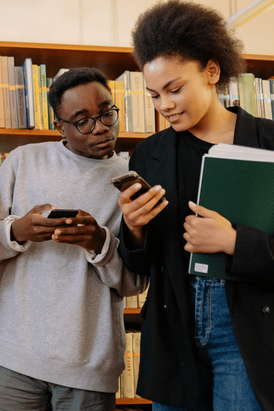 two students using their cell phones