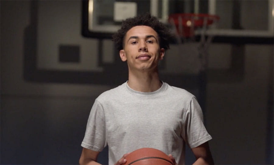 Stroke survivor Dra in gym holding basketball