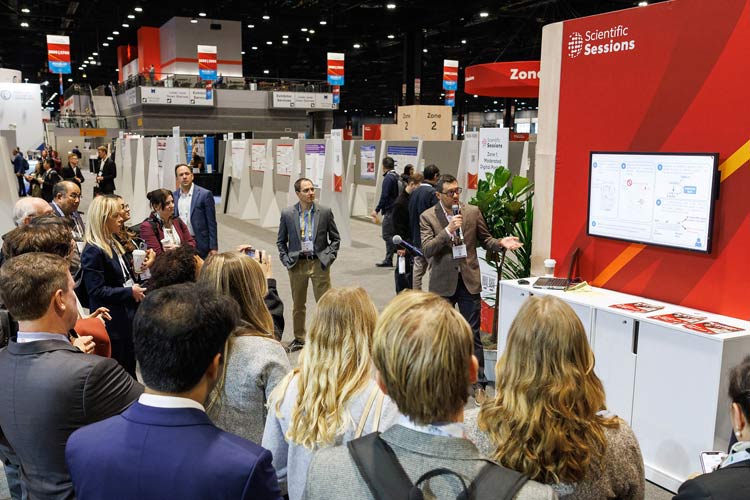 Attendees gather to listen to a moderated poster presenter during #AHA24 in Chicago.