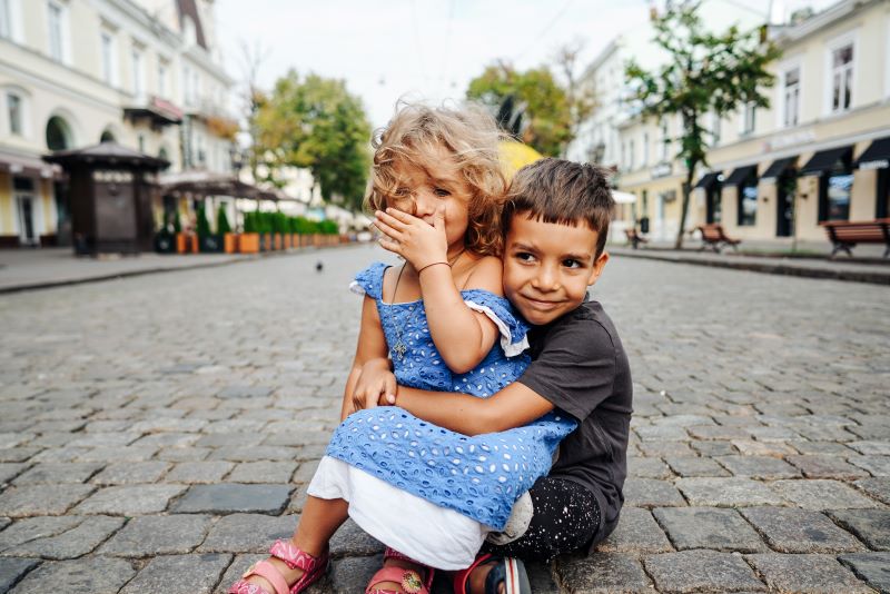 Young children sitting in a street